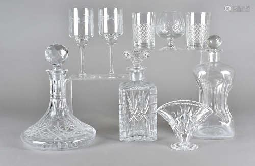 A collection of cut glass decanters, four brandy balloons, six wine glasses with engraved bowls,