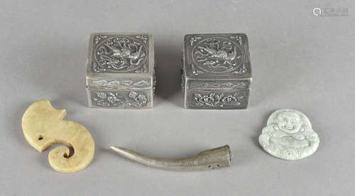 A pair of white metal Chinese hinged boxes, a Mauri style fish hook, Buddha pendant, finger nail