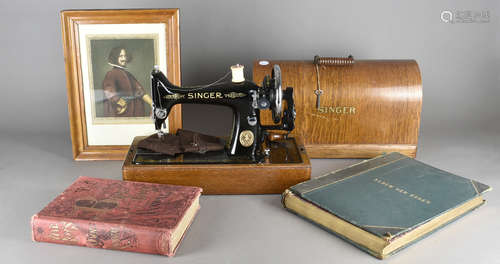 A Singer hand crank sewing machine, in oak case together with a Boys Own Annual, Coronation Book