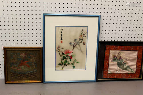 Three framed Chinese embroidery pieces.