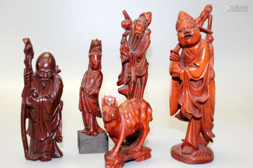 A group of five Chinese carved wood figurines.