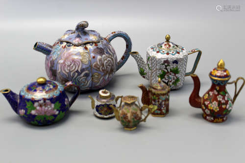 A group of Chinese cloisonne teapots.