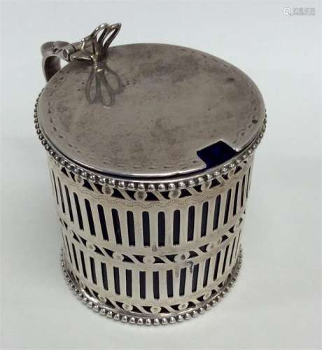 A Georgian silver pierced mustard with hinged top.
