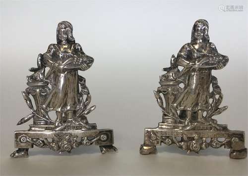 A pair of unusual silver menu holders in the form