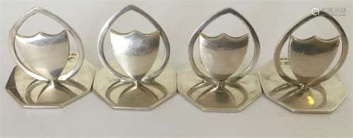 A good set of four silver menu holders with shield