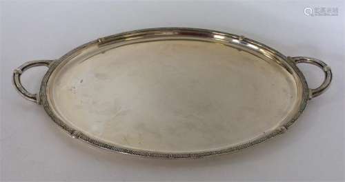 A heavy plain silver tea tray with Celtic-work dec