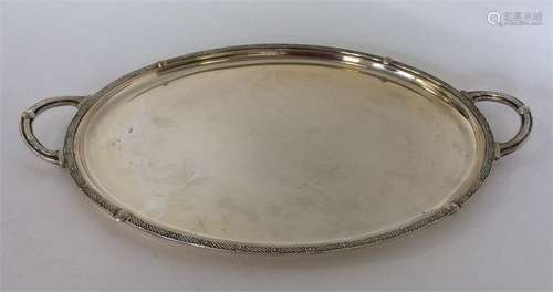 A heavy plain silver tea tray with Celtic-work dec