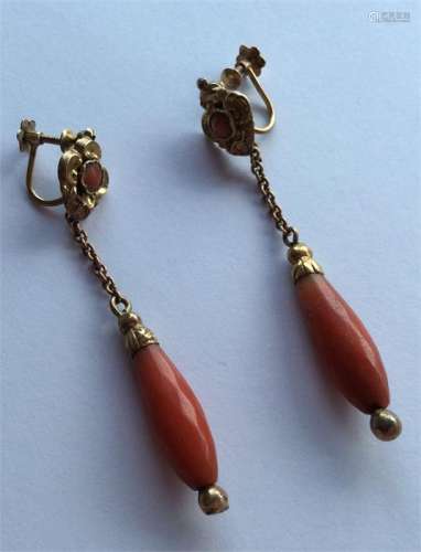 A pair of Antique faceted coral earrings with gold