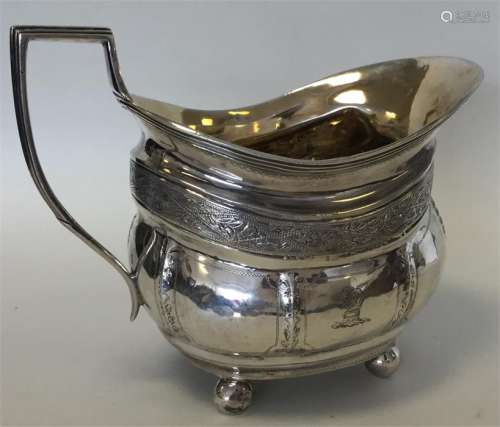 A Georgian silver bright cut cream jug with ball d