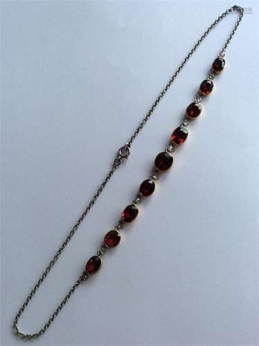 A good gold and garnet necklace with rubover mount