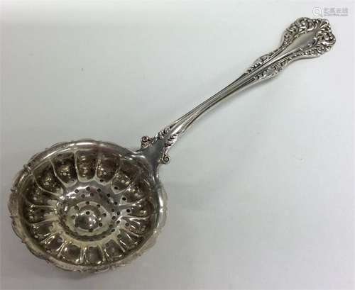 A Continental silver sifter spoon with pierced bow