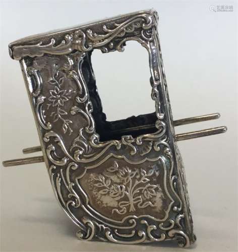 A small embossed silver model of a Sedan chair. Lo