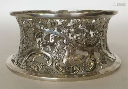 An unusual silver chased and embossed dish ring de
