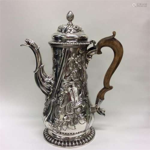 A large George II coffee pot heavily decorated wit