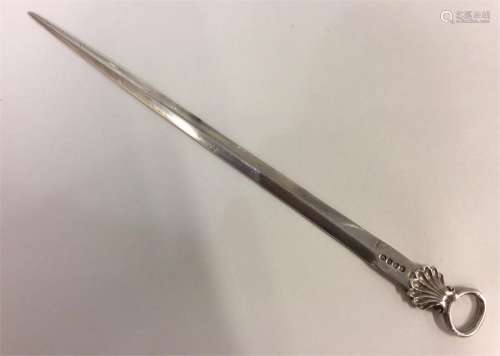 A heavy long silver meat skewer with shell thumbpi