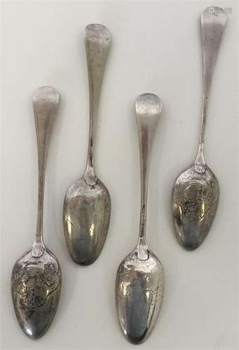 A heavy set of four silver bottom marked teaspoons