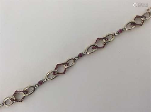 A stylish gold and platinum bracelet with ruby and