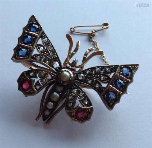 A sapphire, ruby and diamond brooch in the form of