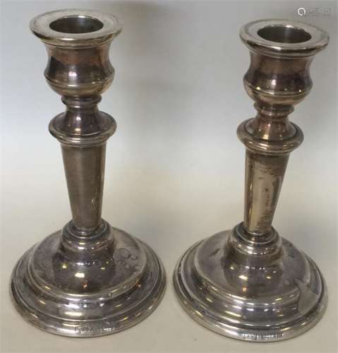 A pair of circular modern silver candlesticks. Lon