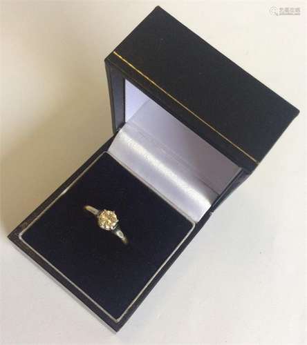 A gold and diamond single stone ring in 18 carat p