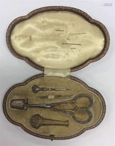 An unusual cased Continental silver gilt sewing bo