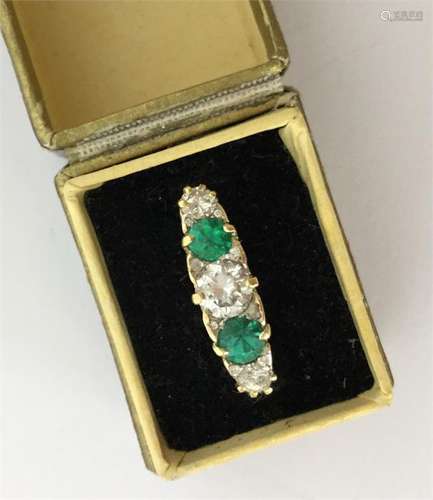 A large emerald and diamond five stone ring in 18