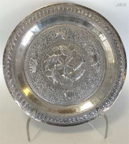 A heavy Indian silver dish profusely decorated wit