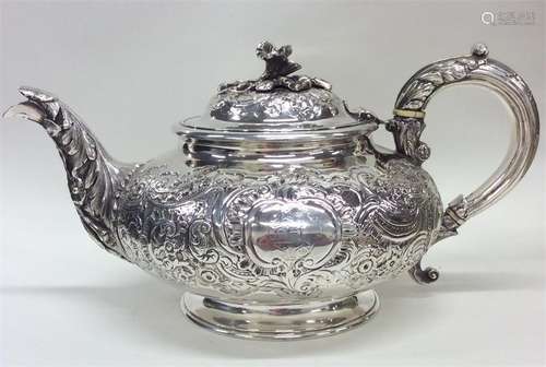 An embossed floral teapot decorated with flowers,