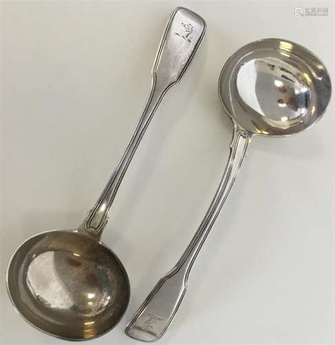 A pair of silver fiddle and thread ladles with cre