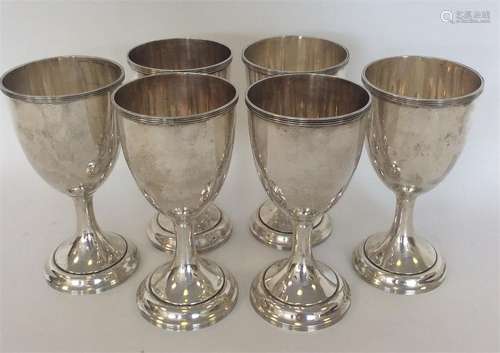 A set of six Sterling silver goblets of tapering form on