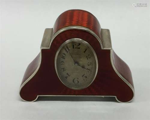 A good quality red enamelled miniature clock with