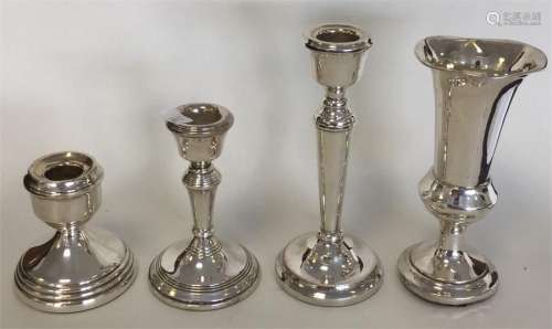 A group of three silver candlesticks of typical de