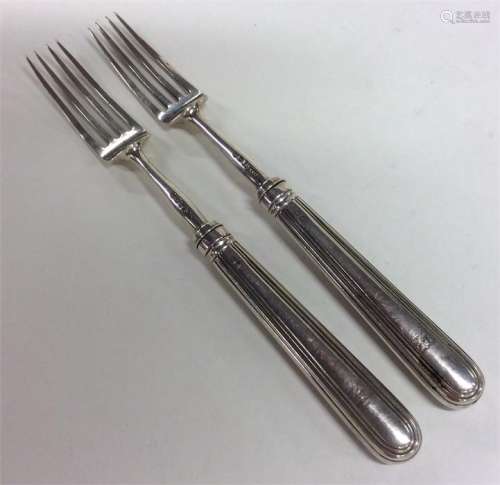 A pair of Georgian silver reeded forks of tapering