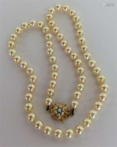 A graduated string of pearl beads with gold star-s