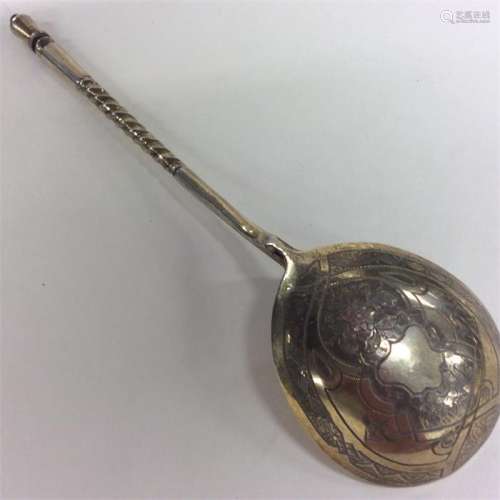 A Russian silver gilt spoon decorated with flowers