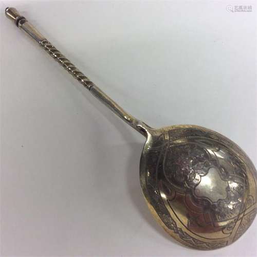 A Russian silver gilt spoon decorated with flowers