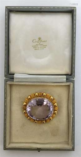 A good large oval amethyst brooch with faceted bod