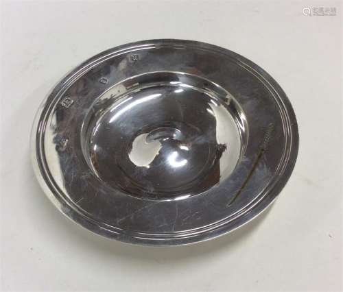 A circular silver Armada dish with reeded decorati