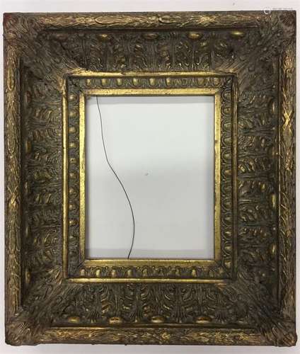 A gilt frame decorated with scrolls and reeding. A