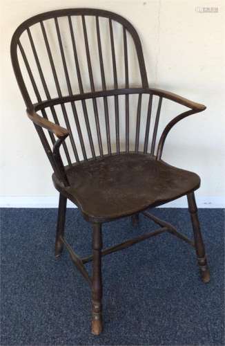 An oak Antique Windsor chair. Est. £60 - £80.