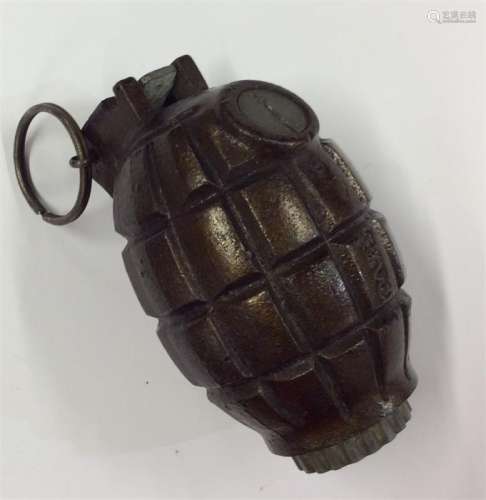 A deactivated hand grenade. Est. £30 - £40.
