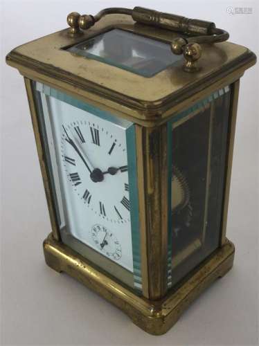 A brass striking carriage clock on bracket feet. E