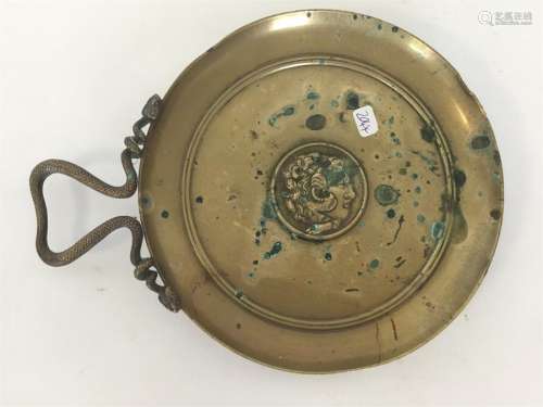 A heavy brass circular dish with snake decoration