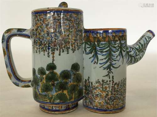 A Continental tin glazed double-cylindrical teapot