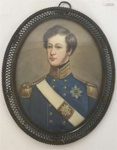 An oval miniature of a soldier in blue jacket, wit