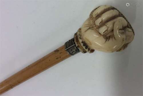 A tapering walking cane with ivory mount carved in