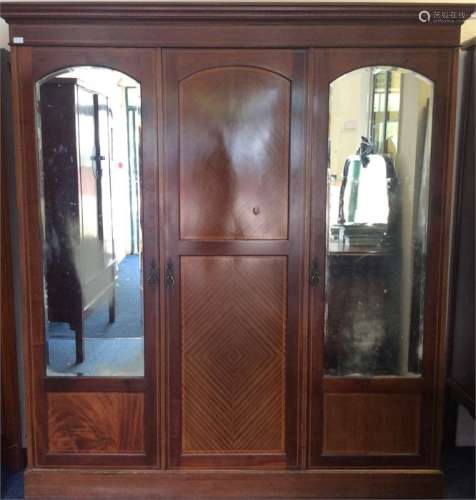 An Edwardian mahogany triple wardrobe with mirrore