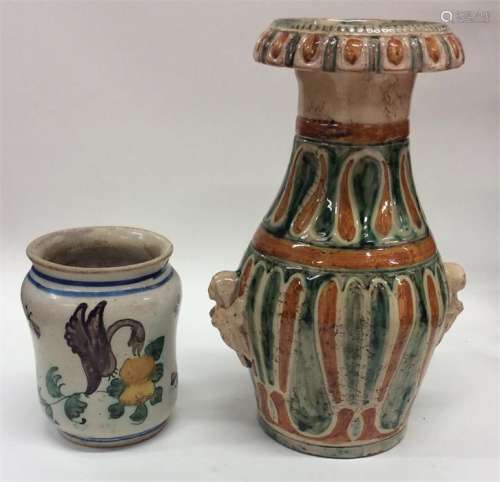 A Continental pottery green and ochre decorated va