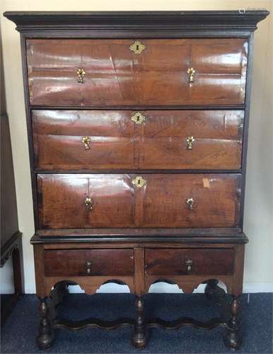 A mahogany veneered three drawer chest on stand wi