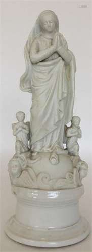 A Parian figure of the Virgin Mary standing with h